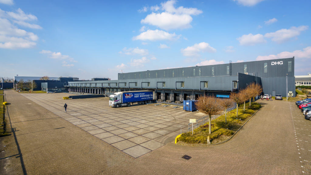 Blue skies with clouds surrounding Dream Industrial warehouse building in the Netherlands.