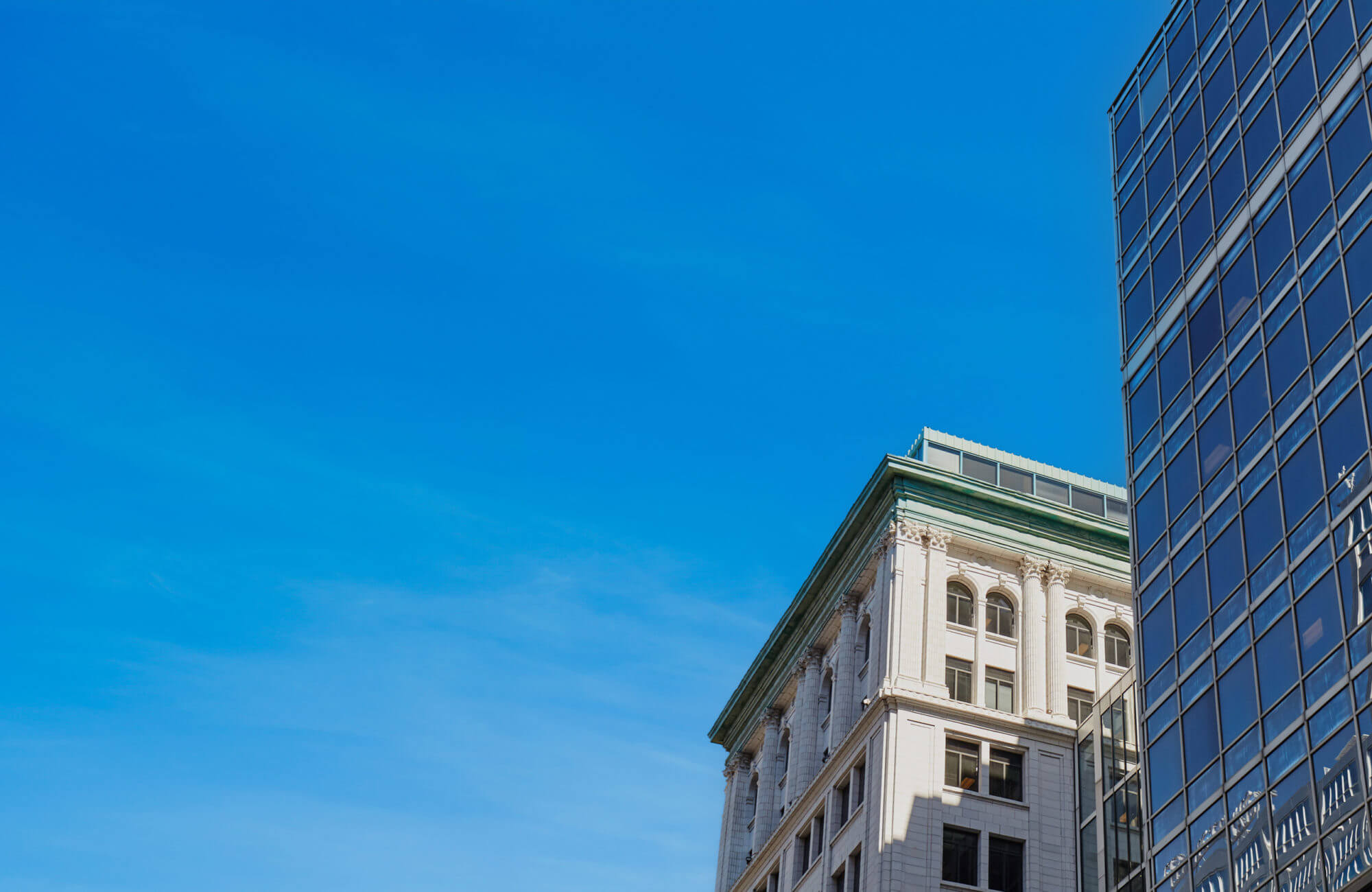 Aerial shot with blue skies of Dream Office REIT's 36 Toronto Street and 30 Adelaide Street East buildings.